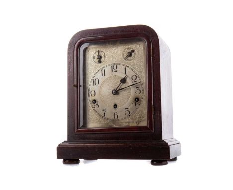 EDWARDIAN MAHOGANY MANTEL CLOCK, with three train German movement striking on five gongs, the silvered dial set with Arabic n