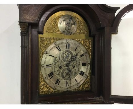 OAK LONGCASE CLOCK, 19TH CENTURY with two train movement, the silvered dial with Roman and Arabic numerals, mounted spandrals