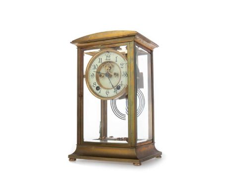 GILT BRASS FOUR GLASS MANTEL CLOCK, EARLY 20TH CENTURY  with two train movement striking on a coil, the exposed escapement wi