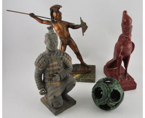 A clay figure of a Xian warrior, a bronzed composite figure of a Roman soldier, a resin figure of an Egyptian bird deity, and