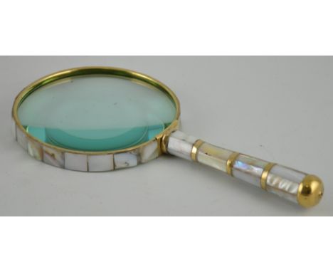 A large brass bound table magnifier set with mother of pearl