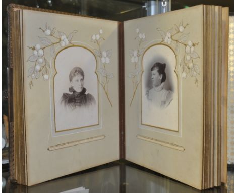 A Victorian photograph album, the embossed leather cover decorated with poppies and a brass clasp, and including a number of 