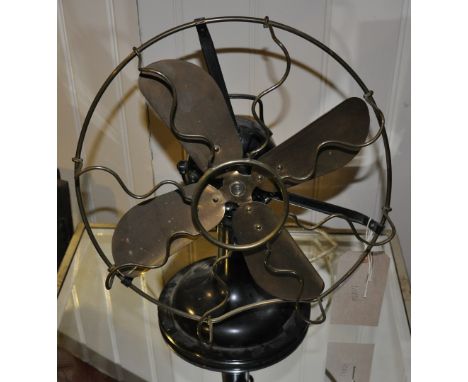 A vintage cast iron and brass propeller desk fan