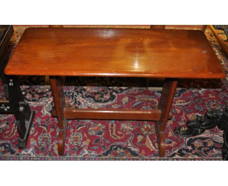 A small Ercol style rectangular occasional table on pierced end standards