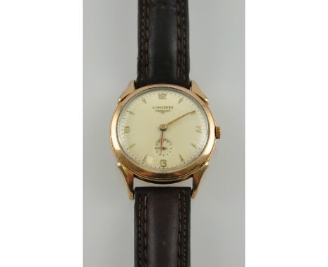 A gentleman's vintage 18ct gold plated Longines wristwatch, the cream dial marked with quarter Arabic numerals and arrow bato