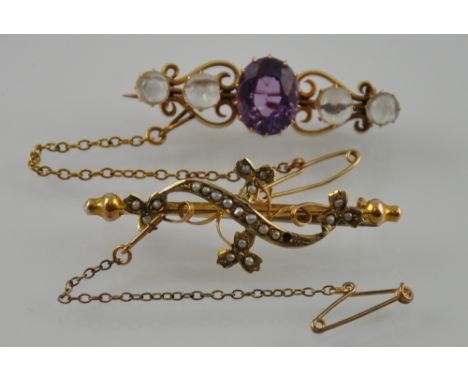 An Edwardian gold lyre scroll bar brooch with faceted amethyst framed by four cabouchon moonstones together with a gold, seed