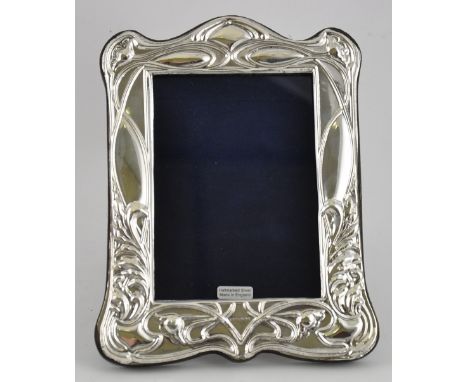 A silver Art Nouveau style easel back photograph frame