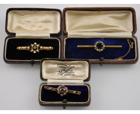 Three cased Edwardian 15ct gold bar brooches set amethyst, peridot, aquamarine and seed pearl