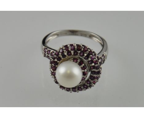 A 9ct white gold garnet and pearl cluster ring