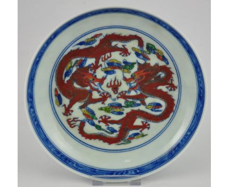 A Chinese blue and white plate decorated with red dragons chasing a pearl, bears a six character Yongzheng style mark to base