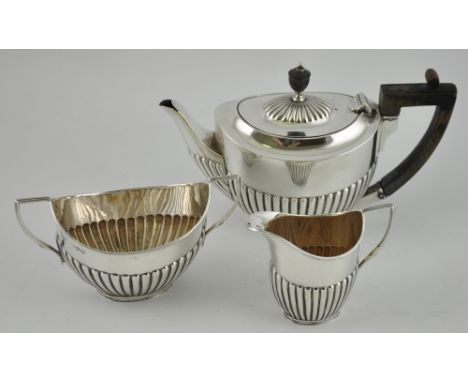 A Victorian silver three-piece Bachelors tea service, by William Hutton & Sons Ltd., London 1895 of oval form, with an emboss