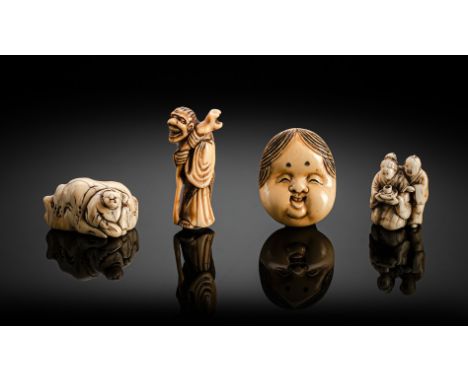 Gruppe von vier Netsuke aus Elfenbein: Maske, Sennin, Knabe an Felsen und PaarJapan, spätes 18.Jh. - Meiji-PeriodeH. 3,5 - 5,