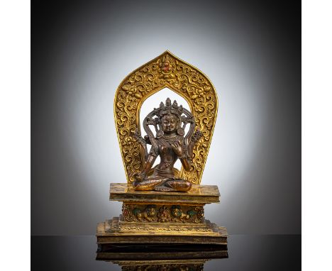 Bronze, wohl Sitapatra auf einem feuervergoldeten ThronTibet, 18. Jh.H. 10/ 21 cmIn vajrasana sitzend, die rechte Hand in For