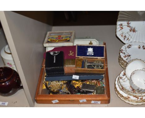 An assorted collection of costume jewellery and watches, including brooches, wristwatches by Timex and Lorus, a silver vesta 