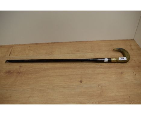 A 19th/20th Century horn handled walking stick, with damage, and having a personalised brass engraved collar