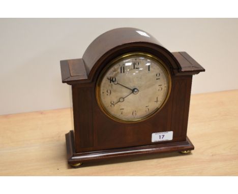 A 19th Century French bonnet top mantel clock, having a silvered Arabic dial, within a mahogany inlaid case, and raised on fo