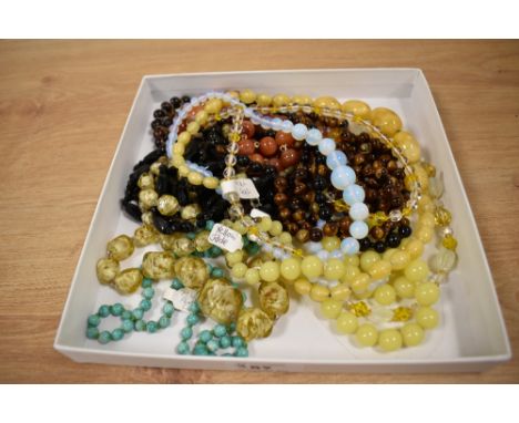 Ten strings of vintage beads including carnelian, tigers eye, opaque glass, jadeite, etc