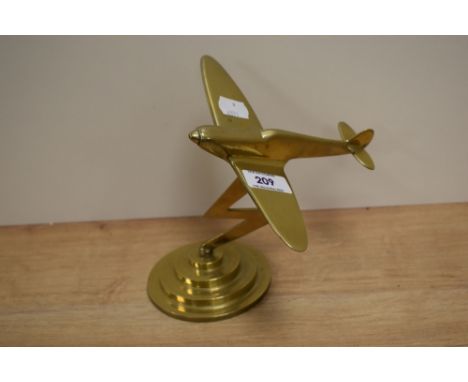 A vintage solid brass fighter plane ornament on stepped base, measuring 18cm tall