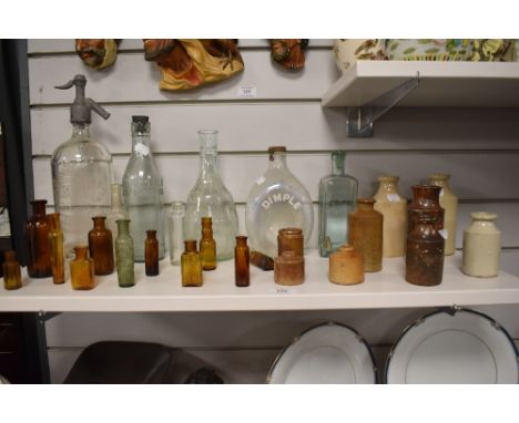 A vintage Taylor &amp; Co. etched glass soda siphon, an assorted collection of codd and other glass bottles, plus amber colou