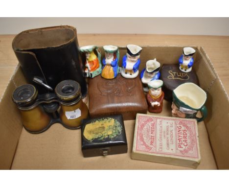 A collection of miniature character jugs, Lemaire opera glasses, playing cards, and oriental boxes