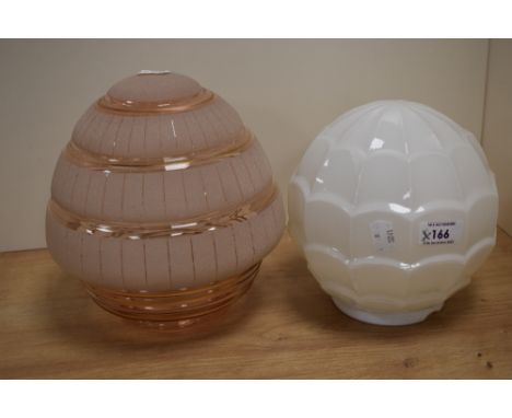 Two vintage lamp shades, including moulded opaque shade and pink frosted shade.