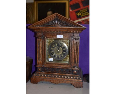 A late 19th Century/early 20th Century Junghans mantel clock, of architectural design, having a silvered Roman dial, two trai
