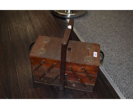 A vintage cantilever action sewing box with ebonised handles