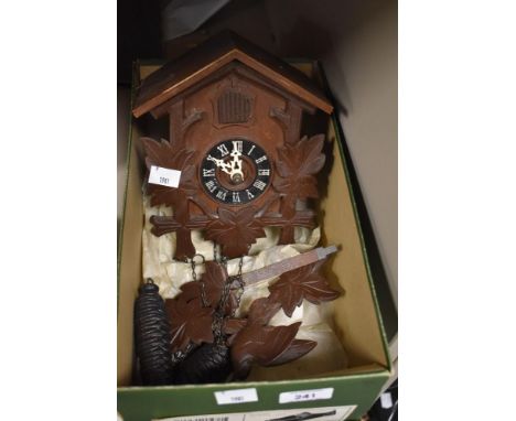 A 20th Century Black Forest style cuckoo clock with acorn weights