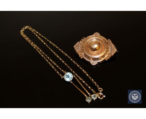 An aquamarine pendant on chain and a 19th century gold brooch 