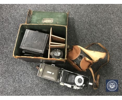 A tray of vintage leather cased box camera with optics and three other cameras 