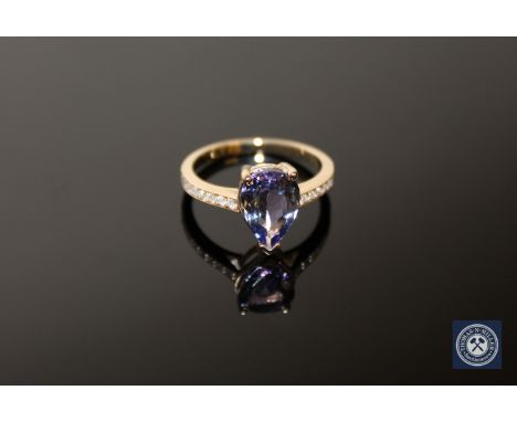 A 14ct yellow gold tanzanite and diamond ring, a pear-cut purplish-blue tanzanite weighing 2.15 carats within a claw setting,