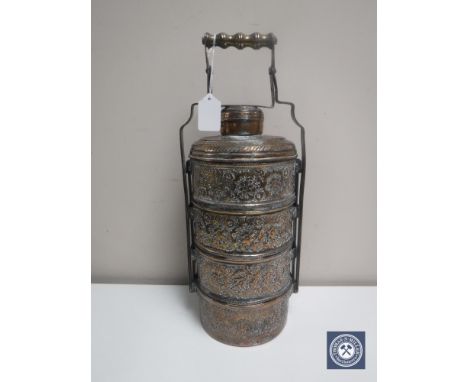 An Eastern embossed four division spice caddy with handle in copper finish