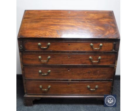 A George III mahogany bureau on bracket feet 