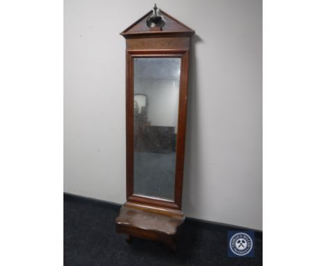 An antique continental hall mirror with shelf 