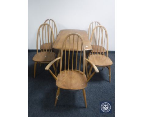 An Ercol elm drop leaf kitchen table and five chairs (one carver, four singles) 