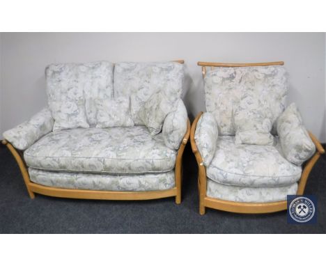 A beech framed three seater Ercol settee and matching armchair 