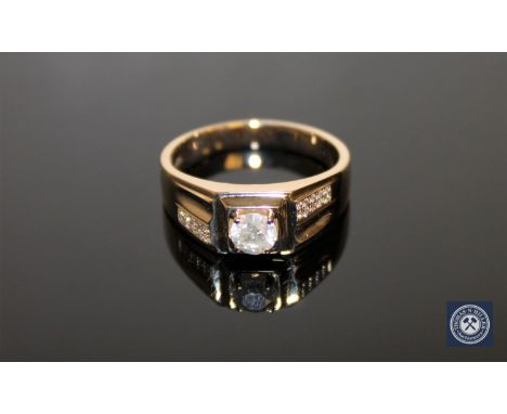 A 14ct yellow gold gent's signet ring, the central brilliant-cut diamond weighing 0.60 carat, clarity P1 and colour H-I, the 