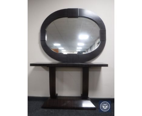 A contemporary console table and mirror in a rosewood finish 