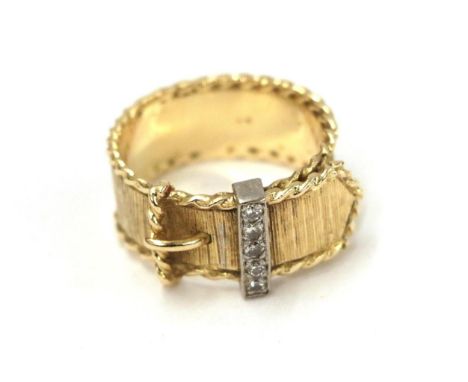 A diamond belt and buckle ring, the yellow textured band with a reeded edge and a buckle motif centrally with an eight-cut di