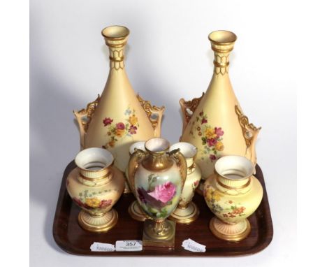 A pair of Royal Worcester blush ivory twin handled vases, two further pairs of Royal Worcester blush ivory vases and a Royal 