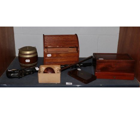 An early 20th century oak stationery cabinet with tambour top; an oak biscuit barrel with plated mounts; a wooden conductor's