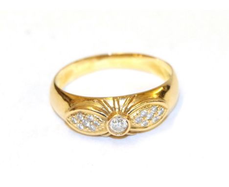 A diamond ring, the bow motif set throughout with round brilliant cut diamonds with the largest to the centre, in yellow claw