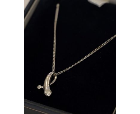 An 18 carat white gold diamond pendant on an 18 carat white gold chain, the tapered loop terminating to round brilliant cut d