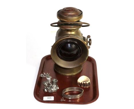 A white metal match holder in a the form of a deer, a silver bangle and a horn napkin ring together with a Lucas King of the 
