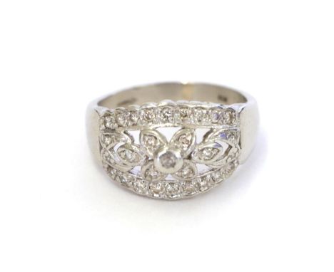 A platinum diamond ring, the central floral cluster flanked by tapered bars set throughout with eight-cut diamonds, in claw a