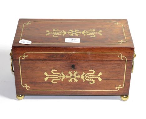 A Regency rosewood and brass inlaid tea caddy with quilt metal mounted lion mask ring handles supported upon four brass ball 