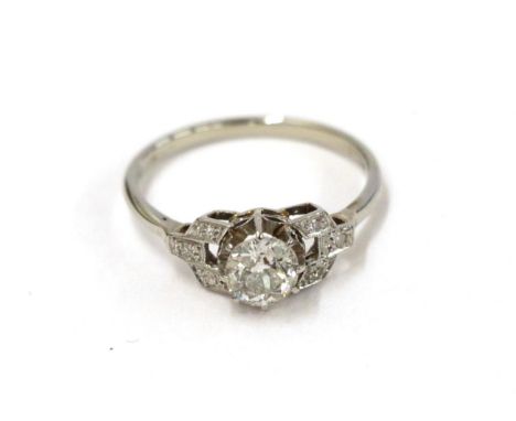 A diamond solitaire ring, the old cut diamond in a white claw setting, to eight-cut diamond set shoulders, to a tapered shoul