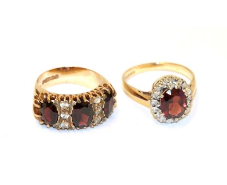 A 9 carat gold garnet and white stone ring, three oval garnets with white stone accents, in yellow claw settings, to a plain 