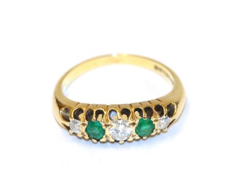 An 18 carat gold emerald and diamond five stone ring, three round brilliant cut diamonds alternate with two round cut emerald