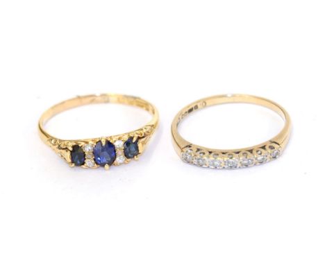 An 18 carat gold synthetic sapphire and diamond ring, three graduated oval sapphires spaced by trios of eight-cut diamonds, i